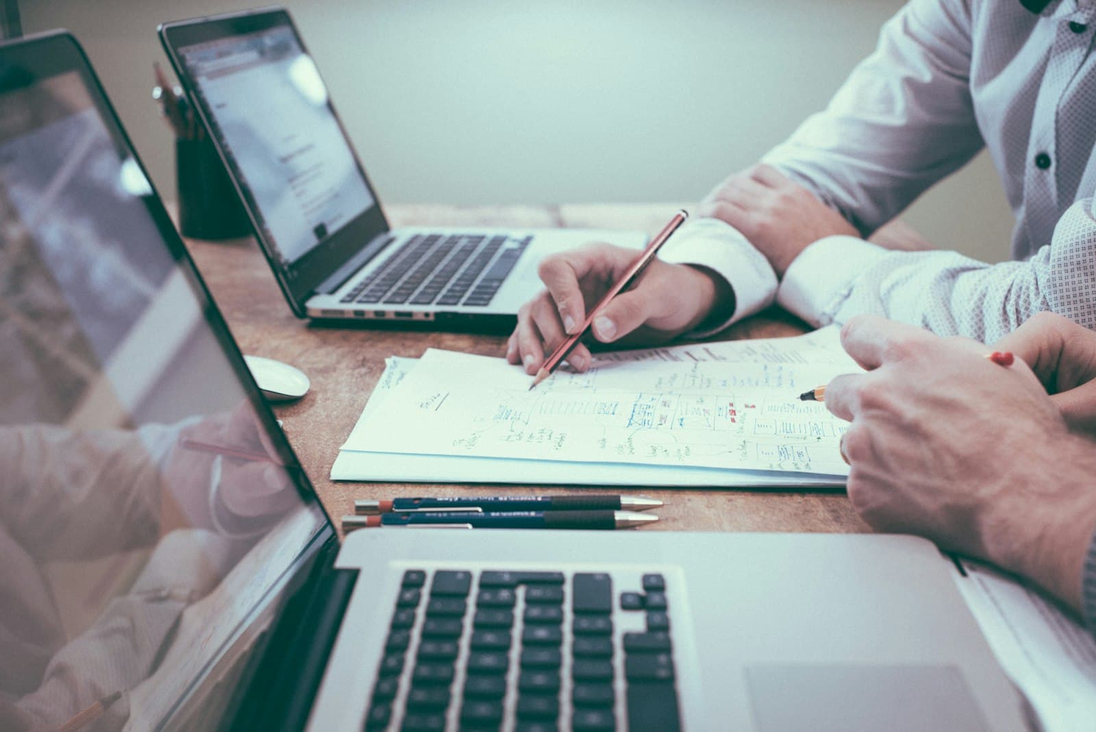 Hands reviewing documents at a desk